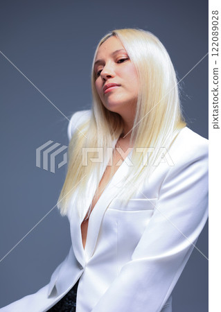 A Stylish and Striking Portrait of a Confident Woman Dressed in a White Suit Ensemble A Stylish and Striking Portrait of a Confident Woman Dressed in a White Suit Ensemble 122089028