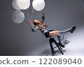 A Playful Child Enjoying Balloons in a Bright and Colorful Studio Setting Full of Life 122089040