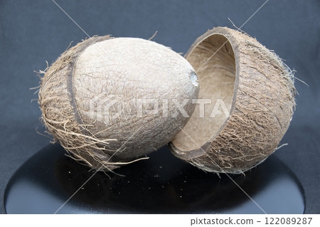 Cracked coconut on gray background Cracked coconut on gray background 122089287