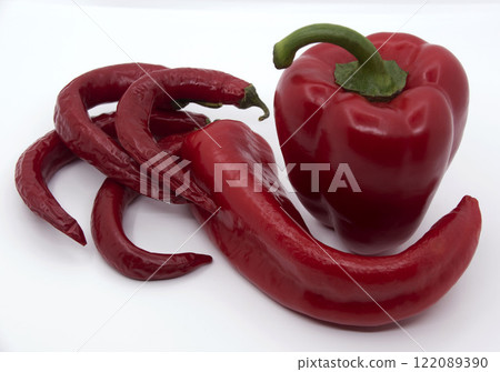 Red bell pepper with capi and hot red peppers on a white background 1 122089390