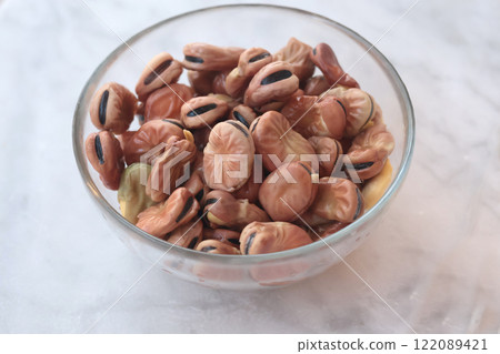 Soaked beans in water in glass bowl on marble table. Food and healthy eating. Protein foods.  122089421