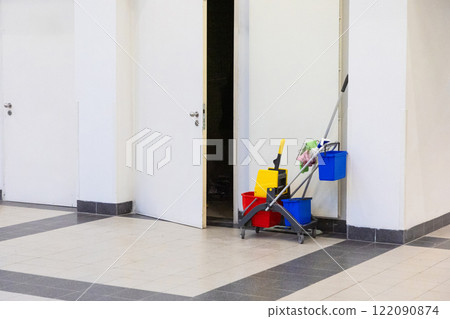 Cleaning products colored buckets for washing stand near open door Cleaning products colored buckets for washing stand near open door 122090874