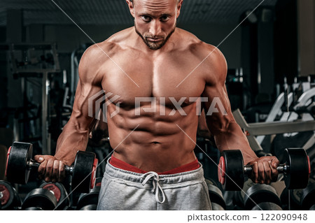 Muscular man doing a exercise for biceps 122090948