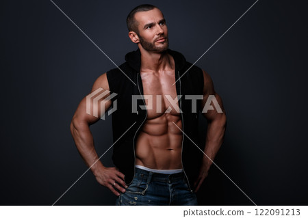 Portrait of handsome muscular man posing in studio Portrait of handsome muscular man posing in studio 122091213