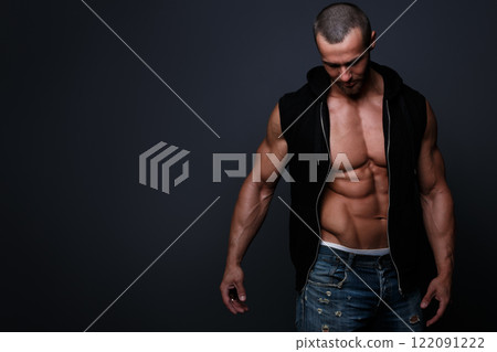Portrait of handsome muscular man posing in studio Portrait of handsome muscular man posing in studio 122091222