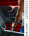 Male hands on control panel of cardio machine 122091523