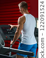 Young muscular man on treadmill in the gym 122091524