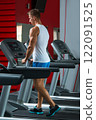 Young muscular man on treadmill in the gym 122091525