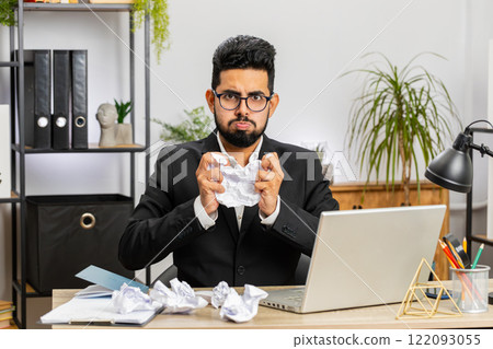 Angry furious man working at home office throwing crumpled paper, having nervous breakdown at work Angry furious man working at home office throwing crumpled paper, having nervous breakdown at work 122093055