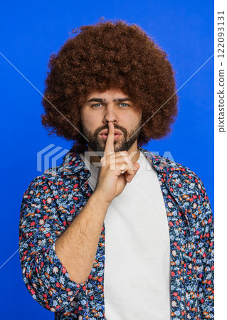 Young man presses finger to lips make silence gesture sign do not tells secret stop gossip privacy 122093131