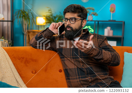 Furious annoyed angry businessman freelancer engage in heated phone quarrel conversations at home 122093132