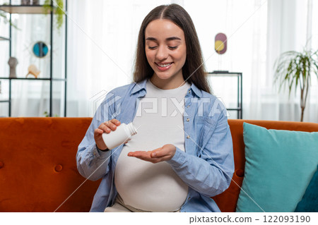 Pregnant young woman taking drug drinking water to nourish unborn child healthy pregnancy concept 122093190