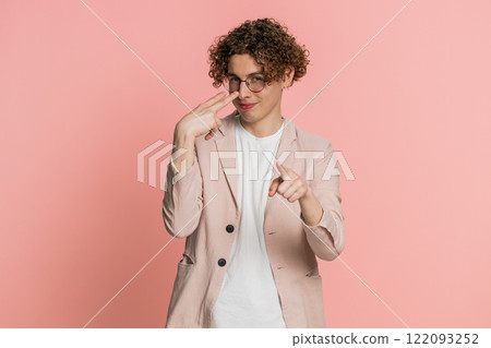 Young man pointing at eyes and camera show I am watching you gesture spying, watching on someone Young man pointing at eyes and camera show I am watching you gesture spying, watching on someone 122093252