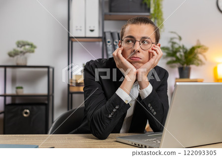 Tired pensive Caucasian businessman thoughtful taking break after laptop work at home office desk 122093305