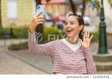 Woman blogger taking selfie on smartphone, video call online with subscribers recording stories 122093348