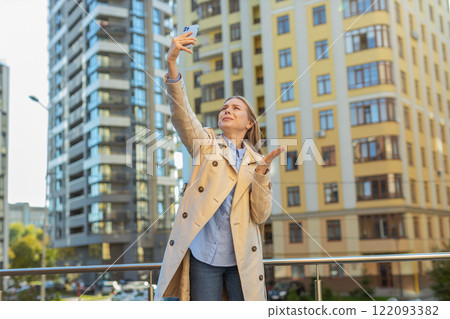 Mature female trying to catch a communication signal or Internet on mobile phone on downtown street Mature female trying to catch a communication signal or Internet on mobile phone on downtown street 122093382