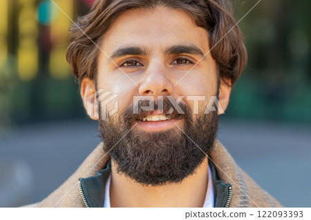 Portrait of happy smiling Indian man looking at camera relaxation feel satisfied on downtown street 122093393