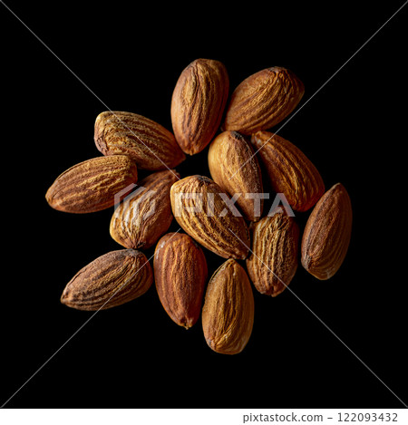 Close-up photo of fragrant roasted almonds, cut out on black background 122093432