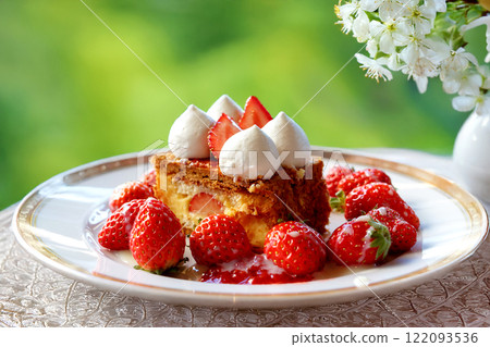 Strawberry and custard cream millefeuille with a green terrace background 122093536