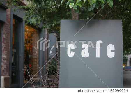 A Lovely and Charming Cafe Sign Nestled and Surrounded by Greenery A Lovely and Charming Cafe Sign Nestled and Surrounded by Greenery 122094014