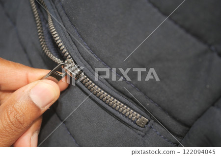 Man zipper on a jacket in cold autumn day. Man zipper on a jacket in cold autumn day. 122094045