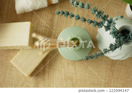 A decorative vase featuring wooden sticks and fresh greenery 122094147