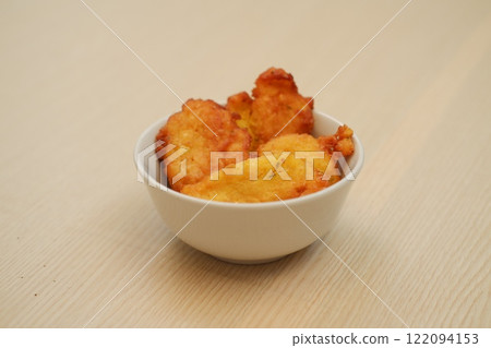 Corn croquettes in a bowl on a wooden table 122094153