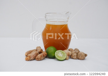 Ginger juice with fresh ginger and lemon on white background. Healthy drink. Ginger juice with fresh ginger and lemon on white background. Healthy drink. 122094240