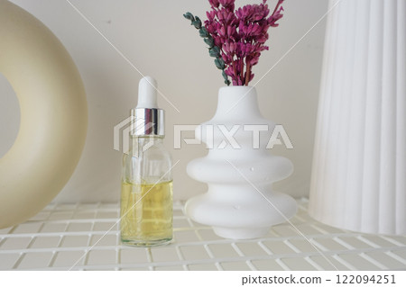 Glass Bottle With Yellow Liquid and Dropper on White Background 122094251
