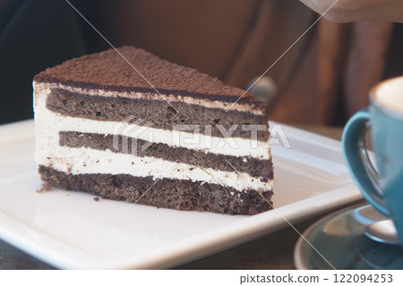 chocolate and cream cake on a plate on table chocolate and cream cake on a plate on table 122094253