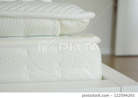 Detailed closeup view of a white mattress showcasing knitted design, offering comfort and style Detailed closeup view of a white mattress showcasing knitted design, offering comfort and style 122094265