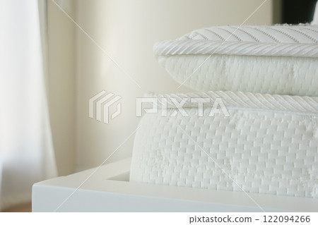 Detailed closeup view of a white mattress showcasing knitted design, offering comfort and style 122094266