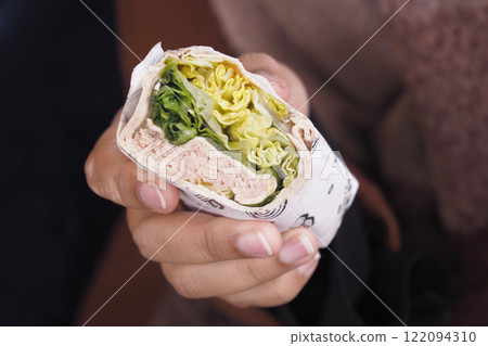 A Freshly Made Wrap Filled with Tasty Greens and Juicy Chicken 122094310