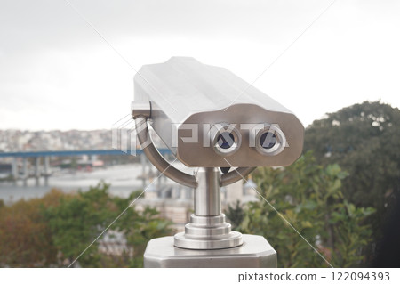Coin-operated binoculars looking out over city , 122094393