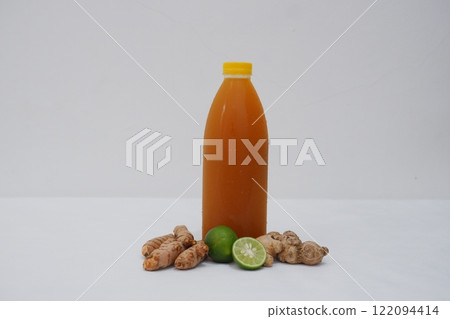 Ginger juice with fresh ginger and lemon on white background. Healthy drink. Ginger juice with fresh ginger and lemon on white background. Healthy drink. 122094414