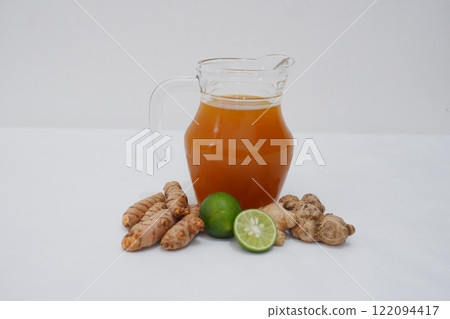 Ginger juice with fresh ginger and lemon on white background. Healthy drink. Ginger juice with fresh ginger and lemon on white background. Healthy drink. 122094417