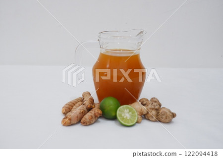 Ginger juice with fresh ginger and lemon on white background. Healthy drink. Ginger juice with fresh ginger and lemon on white background. Healthy drink. 122094418