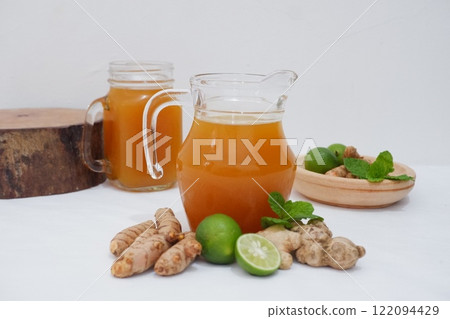 Ginger juice with fresh ginger and lemon on white background. Healthy drink. 122094429