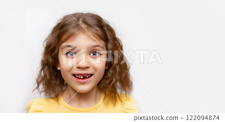 Banner portrait of smiling cheerful funny girl without one front top tooth on gray background 122094874