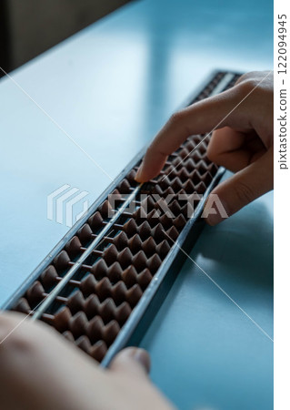 The hands of a person using an abacus The hands of a person using an abacus 122094945