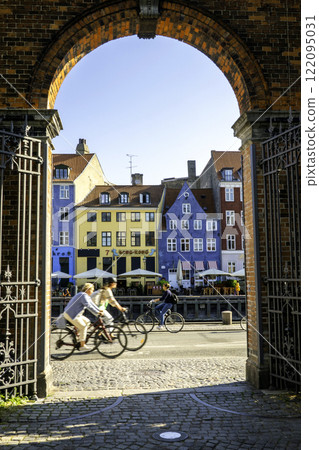 COPENHAGEN, DENMARK - 09 JUN 2023: Nyhavn district is one of the most famous landmark in Copenhagen at sunny day. COPENHAGEN, DENMARK - 09 JUN 2023: Nyhavn district is one of the most famous landmark in Copenhagen at sunny day. 122095031