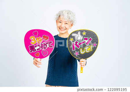 Senior woman holding a fan 122095195