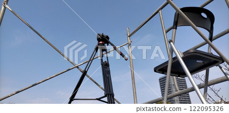 Tripod and folding chair at event photography location 122095326