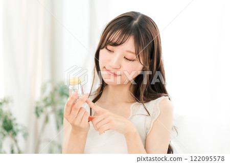 A smiling Asian woman checking the ingredients of medicines and supplements 122095578