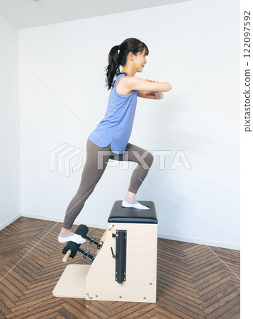 Woman doing machine pilates training 122097592