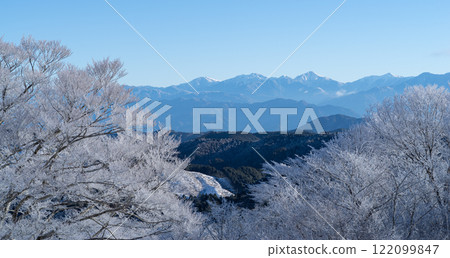 Hoarfrost-covered trees and snow-capped mountains of the Southern Alps Hoarfrost-covered trees and snow-capped mountains of the Southern Alps 122099847