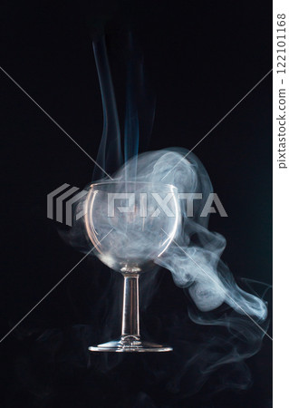 levitating glass full of smoke on a black background levitating glass full of smoke on a black background 122101168