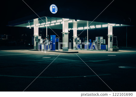 A gas station shining in the silence of the night 122101690
