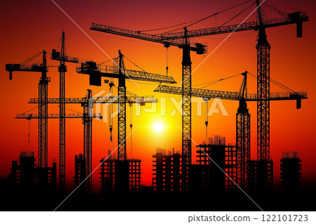 Sunset Over Construction Site with Cranes Silhouetted Against Vibrant Sky Colors 122101723