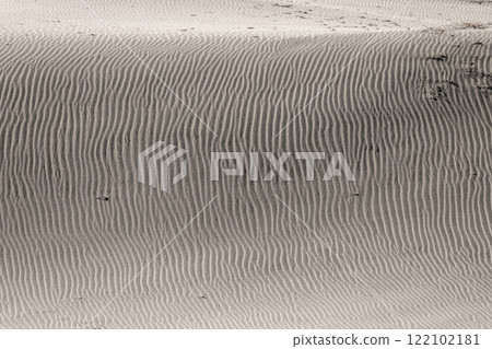 Beautiful sand ripples created by the wind blowing across the sand dunes Beautiful sand ripples created by the wind blowing across the sand dunes 122102181